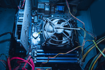 Dust on computer pc processor cooler with mainboard and computer case fragment.