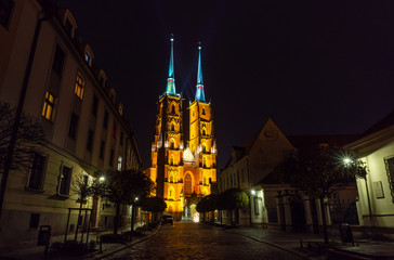 Wroclaw. View at night of the historical district Ostrow Tumski with the spires illuminated of the cathedral of St. John the Baptist