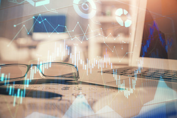 Financial chart hologram with glasses on the table background. Concept of business. Double exposure.