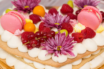 Obraz na płótnie Canvas Beautiful birthday cake decorated with decor and fresh berries