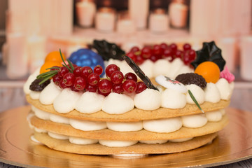 Beautiful birthday cake decorated with decor and fresh berries