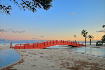 Evening landscape with a bridge on the beach of the island of Palma de Mallorca.