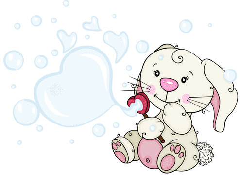 Funny little bunny blowing soap bubbles