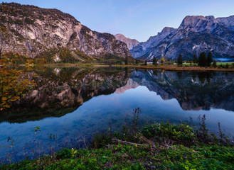 Fototapeta premium Autumn evening Alps mountain lake with clear transparent water and reflections. Almsee lake, Upper Austria.