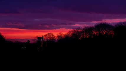 Brora War Memorial at sunrise with dawn colours in the sky