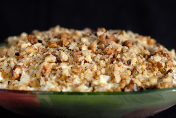 Salad seasoned with mayonnaise and sprinkled with chopped nuts. Shallow depth of fields