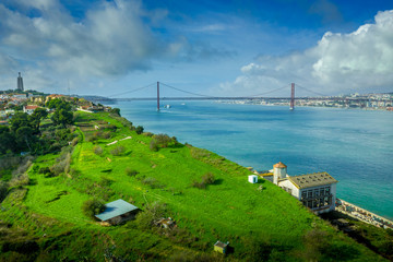 Fototapeta premium Aerial panoramic view of the April 25 Bridge over the Tagus river between Lisbon and Almada