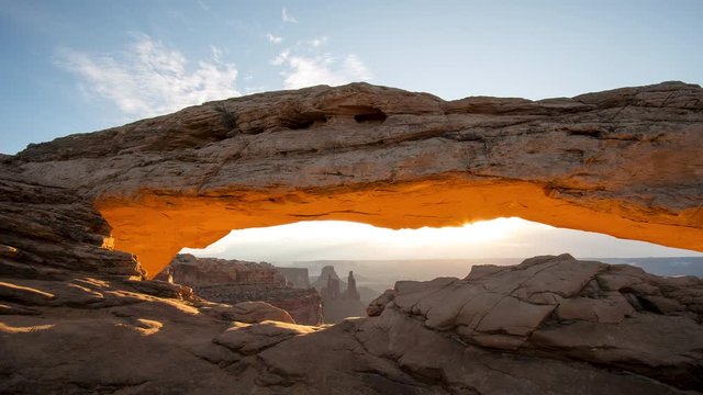 Timelapse of Mesa Arch glowing as the sun shines over the desert at sunrise in Canyonlands.