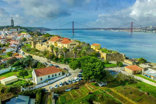 Aerial view of Almada castle with the Targus river and the April 25th bridge in the background