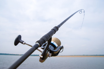 Fishing rod with reel close-up.