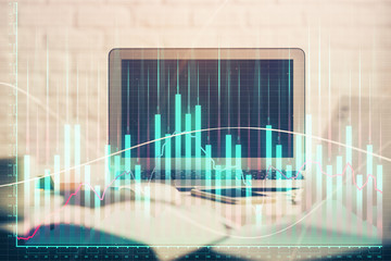 Forex market chart hologram and personal computer background. Double exposure. Concept of investment.