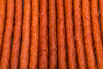 Kabanos or Cabanossi Thin Dry Smoked Polish Sausage Background. Selective focus.