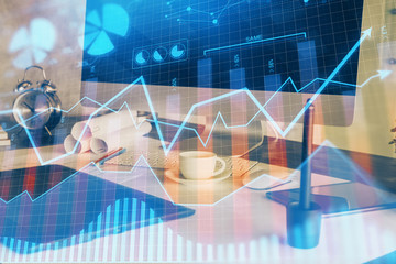Financial chart drawing and table with computer on background. Multi exposure. Concept of...