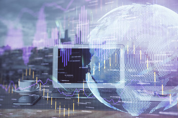 Financial graph colorful drawing and table with computer on background. Multi exposure. Concept of international markets.
