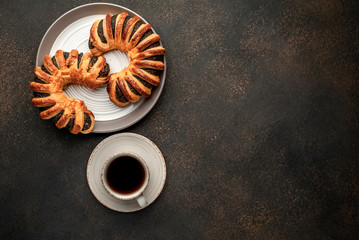 coffee and tasty bagels with poppy seeds on a cutting board with copy space for your text. concept...