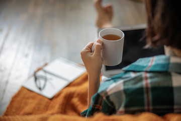 Close up of lady sitting with cup of hot drink