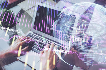 Double exposure of businessman with laptop and stock market forex chart.