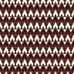 Ethnic style seamless pattern with repeated triangles. Zigzag lines motif. Tribal geometric ornament.