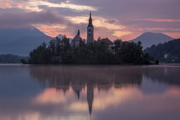 Fototapeta na wymiar Bled Lake island and church at sunrise