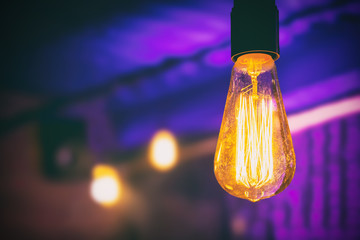 Incandescent lamps in a modern cafe on a blurred background