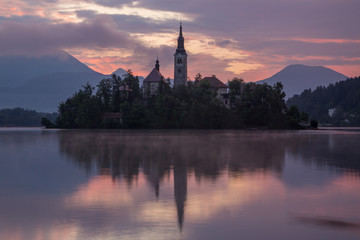 Fototapeta na wymiar Bled Lake island and church at sunrise