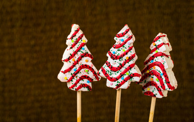 Christmas Tree Cakes Pops on Stick. Christmas Background. Selective focus.