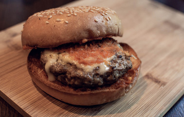 Beef burger on wooden tray