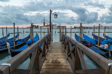 Fototapeta premium Gondolas docked at the pier in Venice