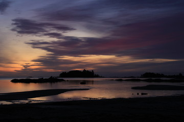 Sunrise scene at the shore of Lake Vanern, largest Lake of Sweden and the European Union. Rock formation and small island.