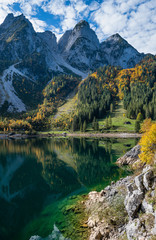 Fototapeta na wymiar Autumn Alps mountain lake with clear transparent water and reflections. Gosauseen or Vorderer Gosausee lake, Upper Austria.