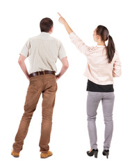 Back view of a stylish couple pointing.