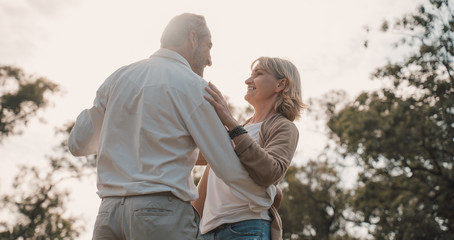 Older Lover and dating concept.Beautiful Senior couple romantic dancing in park.mature couple in...