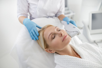 Specialist doing a facelift to female patient