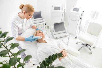 Beautiful lady doing hardware facelift in beauty salon