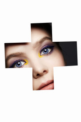 female face with color makeup into paper hole. make-up concept