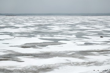 Flying above frozen lake surface