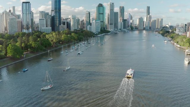 A drone shot of Brisbane city at sunset featuring a CityCat ferry from Kangaroo Point. Brisbane, Australia.