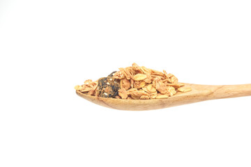 Granola mixed berry in the wooden spoon isolated on a white background.