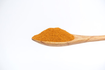 Cayenne in the wooden spoon isolated on a white background.