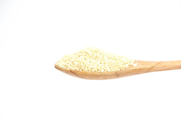 White sesame grain in the wooden spoon isolated on a white background.