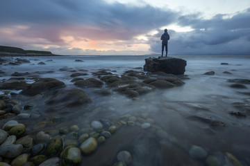 Man standing on a rock of the Irish coast