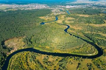 Aerial View Green Forest Woods And River Landscape In Sunny Summer Day. Top View Of Beautiful European Nature From High Attitude In Summer Season. Drone View. Bird's Eye View