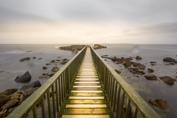 Obraz premium Pier of Ballycastle on a peaceful morning at the beach