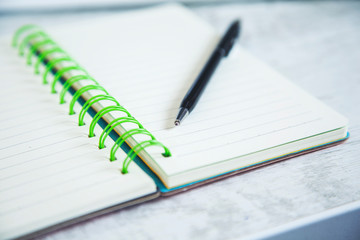 pen on notepad on desk