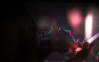 business man or stock trader analyzing stock graph chart by fibonacci indicator, business man holding tablet for buy or sell, double exposure stock graph and person, market graph analysis concept