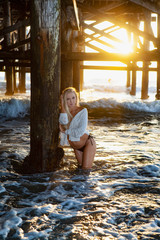 blond woman under a pier
