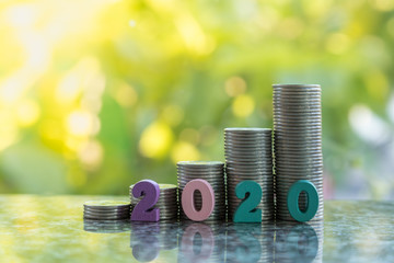 2010 New year, Money and Business Concept. Close up of colorful number wooden in front of stack of...