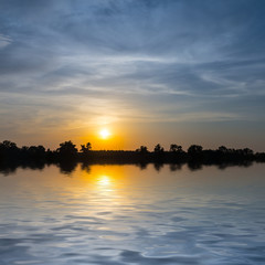 Fototapeta premium dramatic sunset reflected in a quiet lake, nice outdoor twilight background