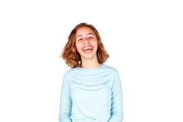 Fototapeta premium Beautiful young girl with curly hair crazy laughs with open mouth. Happy teenager, isolated