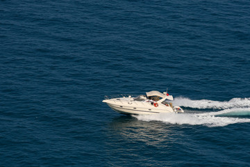 The speedboat traveling fast in the Mediterranean Sea and the trail it left behind